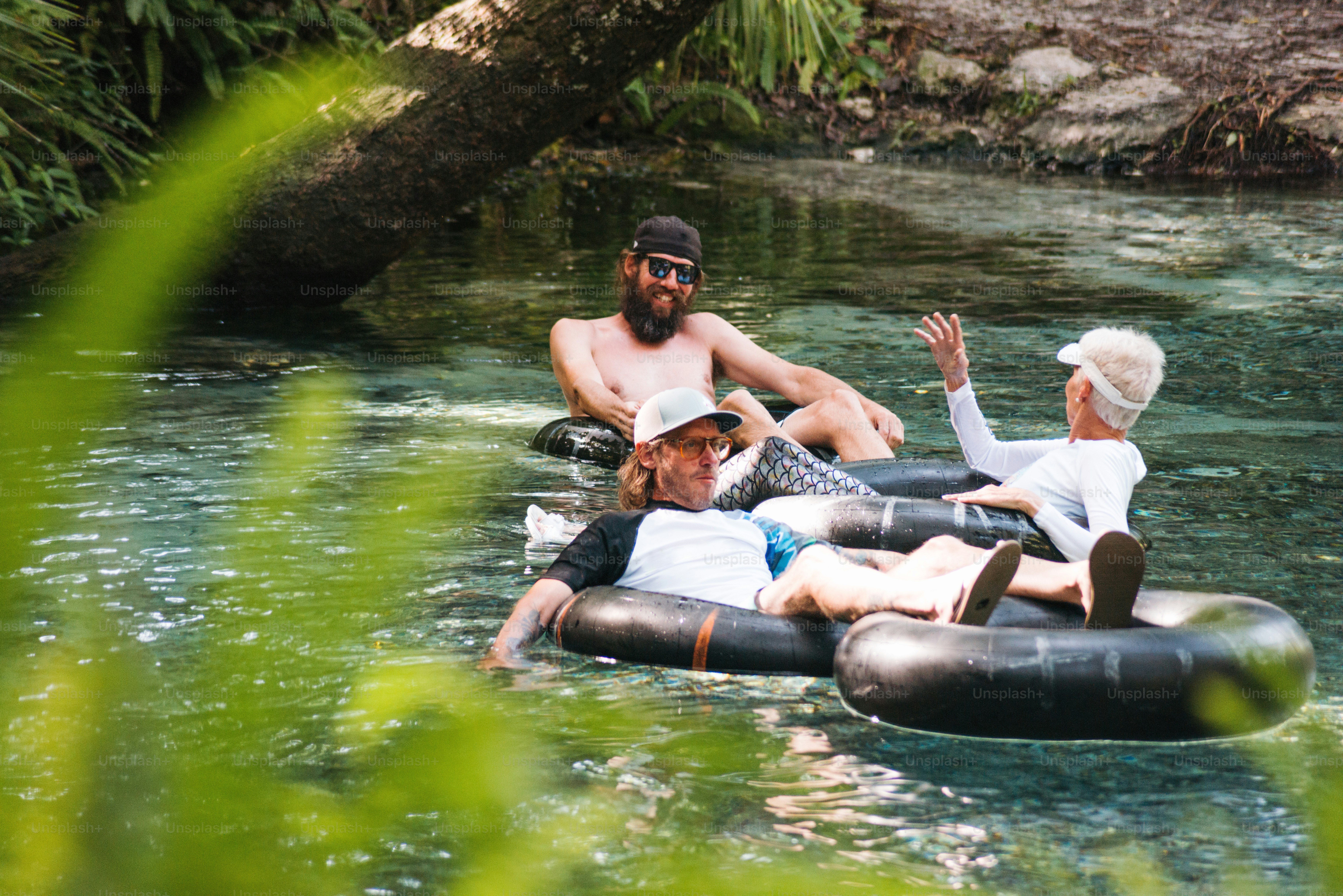 a group of people floating on top of an inflatable raft